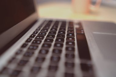 Perspective of the keyboard of a laptop in black and white blur. Selective focus.