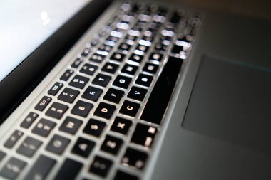 Perspective of the keyboard of a laptop in black and white blur. Selective focus.