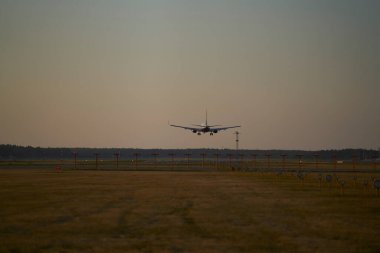 10-05-2021 Riga, Latvia Silhouette of a passenger plane taking off from the airport.