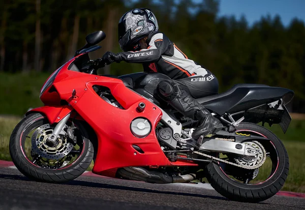 11-05-2020 Riga, Latvia Motorcyclist at sport bike rides by empty asphalt road. sport bike. MotoGP race. Superbikes. Motorbikes racing