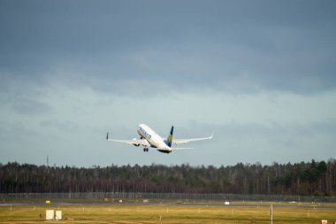 15-01-2022 Riga, Latvia White Passenger plane fly up over take-off runway from airport