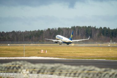 15-01-2022 Riga, Latvia White Passenger plane fly up over take-off runway from airport