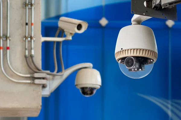 3 CCTV camera or surveillance operating on blue bakcground — Stock Photo, Image