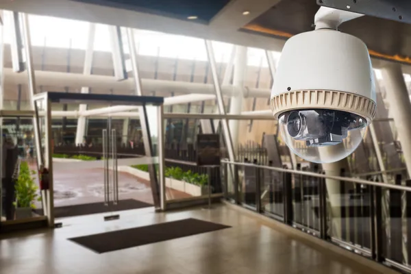 CCTV Camera operating in front of glass door — Stock Photo, Image