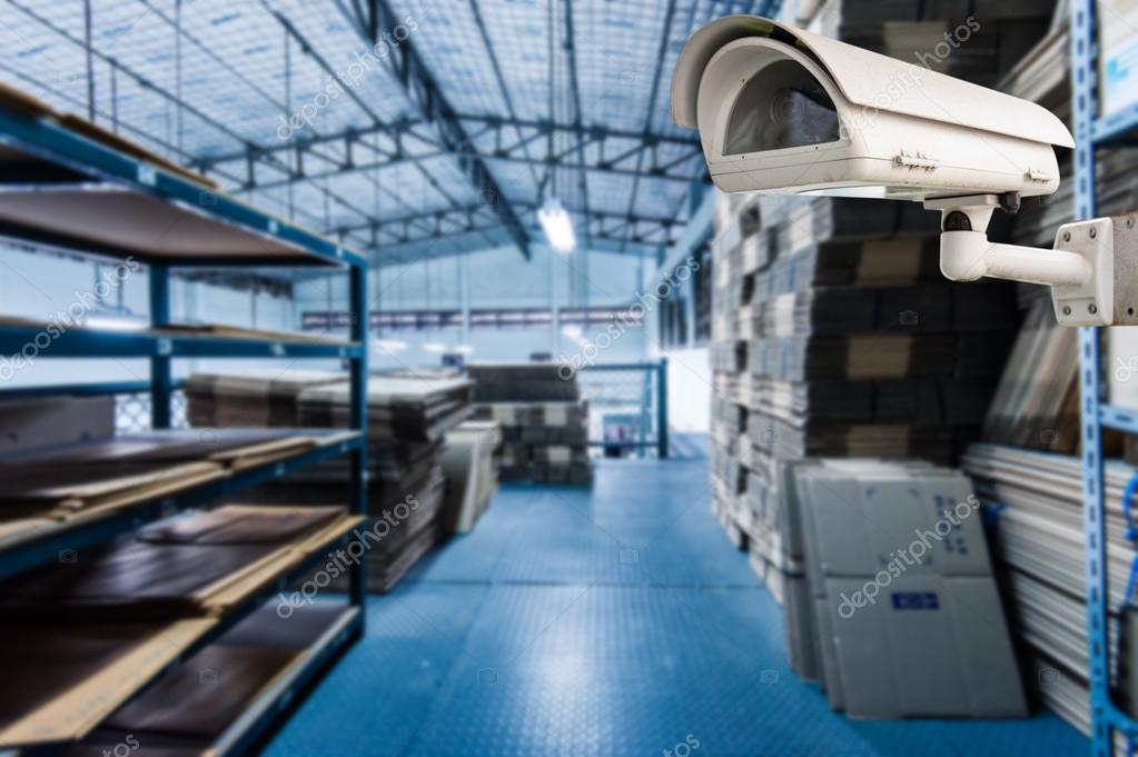 CCTV Camera Operating inside warehouse or factory Stock Photo by