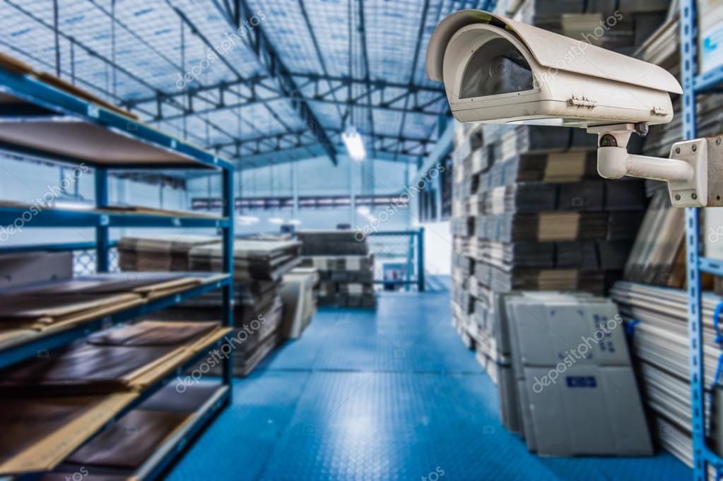 CCTV Camera Operating inside warehouse or factory Stock Photo by