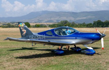 Stanesti, Gorj, Romania  August 27, 2022: Unidentified people visit small sports planes at the aviation rally, Stanesti aerodrome, Gorj, Romania