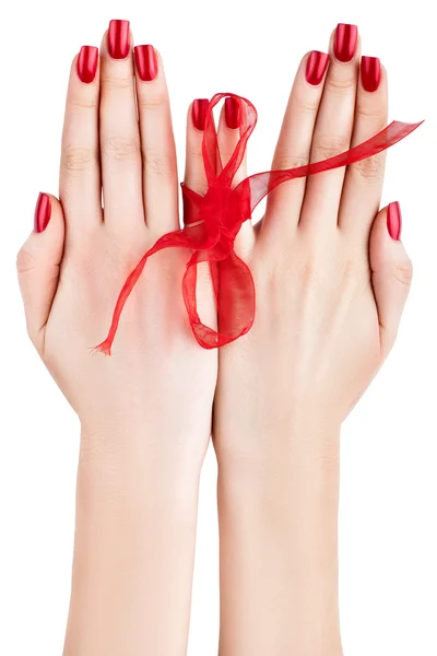Hands with red ribbon. — Stock Photo, Image