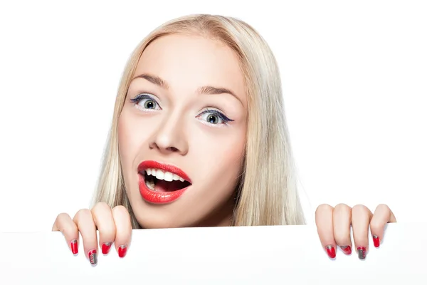 Blonde girl peeking out from behind the poster. — Stock Photo, Image