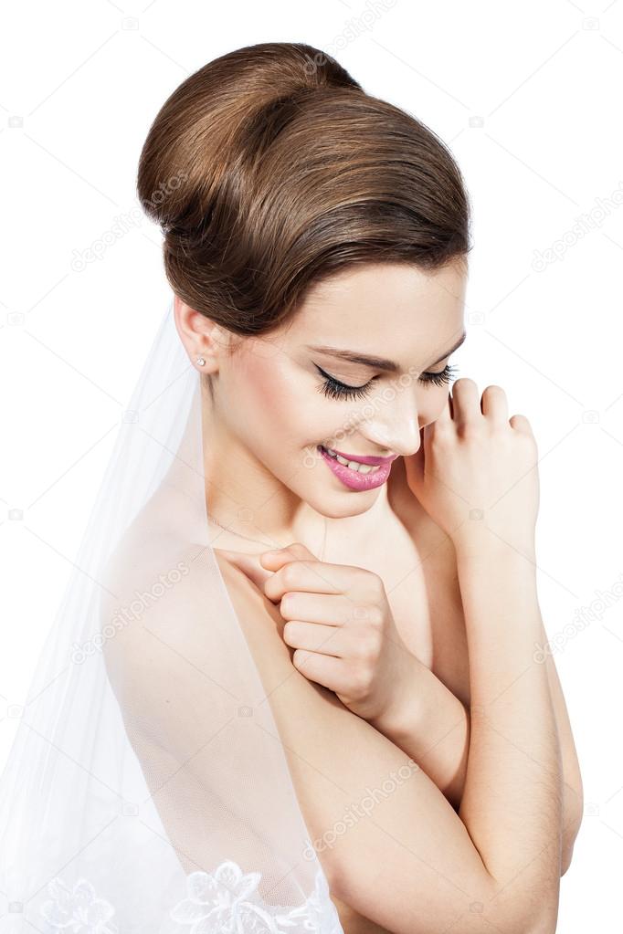 Rubs bride with a veil, she gently smiling.
