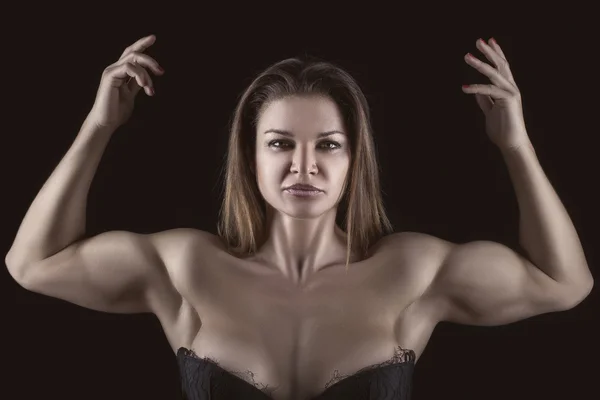 Bodybuilder girl with hands raised up. — Stock Photo, Image