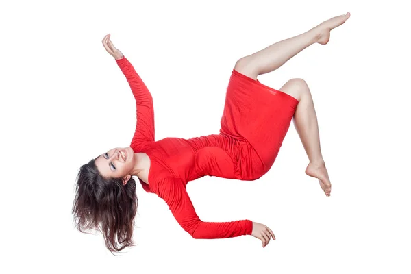 Woman in red dress laughs and falls. — Stock Photo, Image