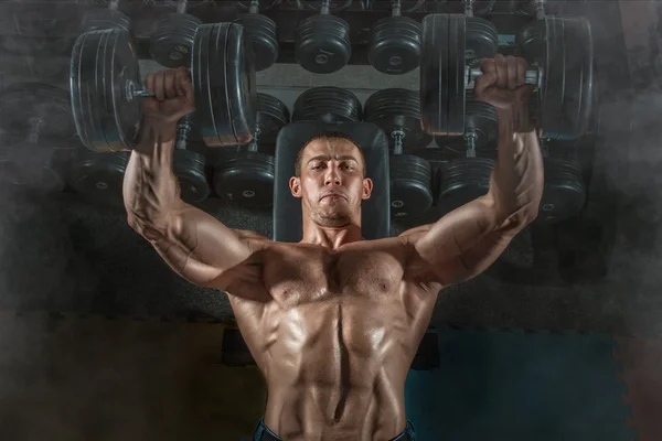 Bodybuilder dumbbell presses — Stock Photo, Image