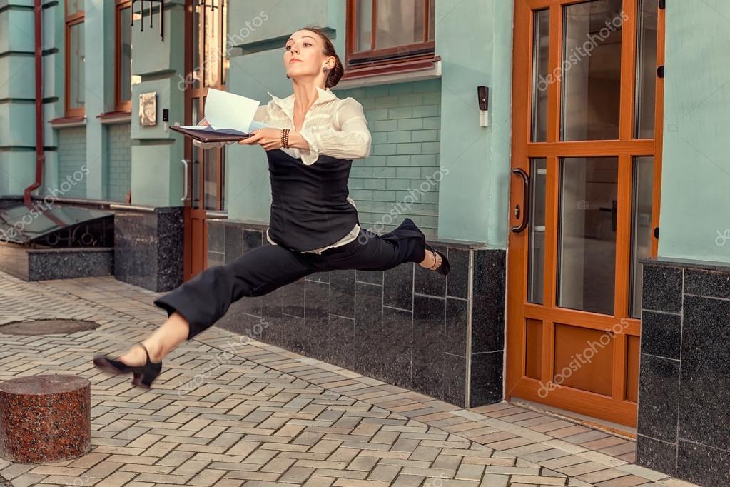 Woman runner running rush to carry documents to the office.