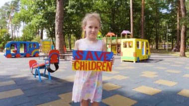 Ukrainian girl in her hands holds a poster with the inscription save the children. She asks for help to save from the war.