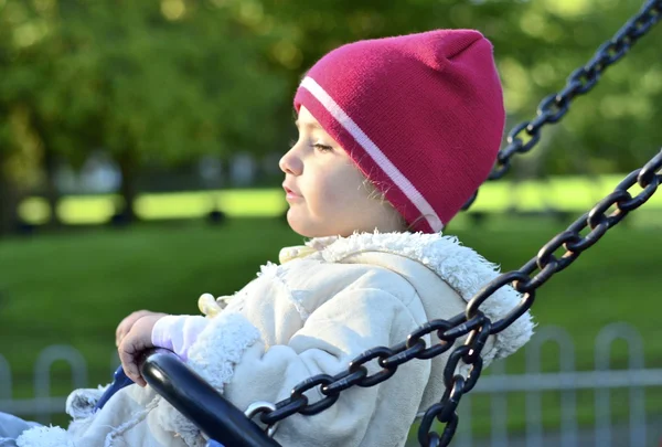 Young child playing on a swing — Stock Photo, Image