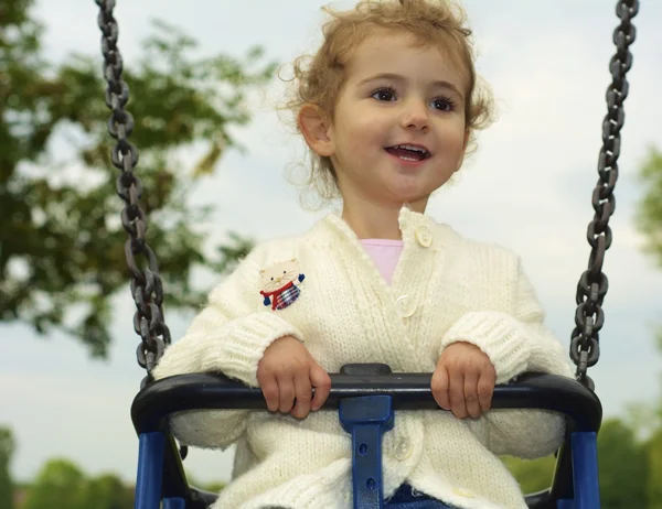 Young child playing on a swing Stock Photo