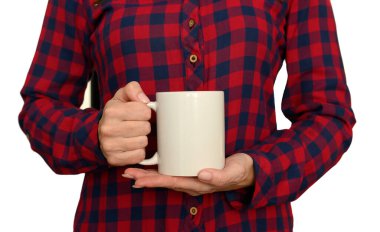 Female hands in a plaid shirt hold a white mug. Layout. Close-up. On white background.