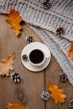 Kurabiye, yaprak ve koni ile ahşap bir masada bir fincan kahve.