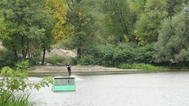 Wakeboarder saute trampoline et atterrit sur la surface de l'eau remorqué — Video