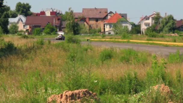 Countryside landscape, Ford Mustang Fastback drives into focus — Stock Video