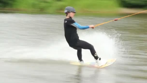 Wake-boarder falls after jumping on trampoline, amateur semi-pro — Stock Video