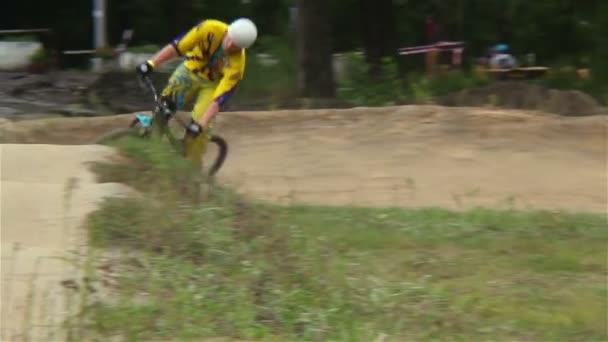 Rider in yellow sport suit races against time circuit race — Stock Video