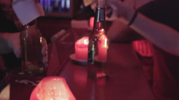 Barman in night club bar gives bottles with alcohol — Stock Video