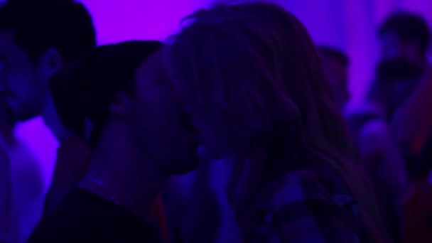 Couple is kissing in night club. Man and woman making out on dance floor — Stock Video