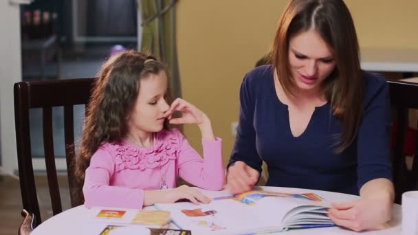 Мать учит свою маленькую дочь — стоковое видео