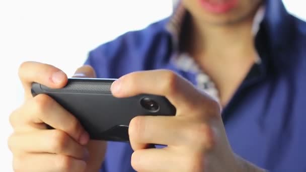 Man playing sensor games on touch phone — Stock Video