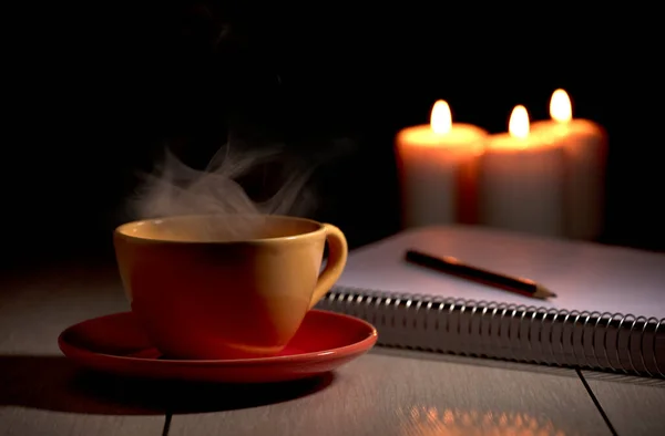 Cup Hot Coffee Yellow Smoke Notebook Pencil Burning Candles Desk — Stock Photo, Image