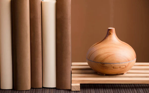 Purificador Óleo Essencial Sobre Madeira Com Livros Sobre Mesa Fundo — Fotografia de Stock