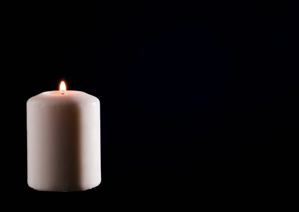 Wax candle with a dark back flame