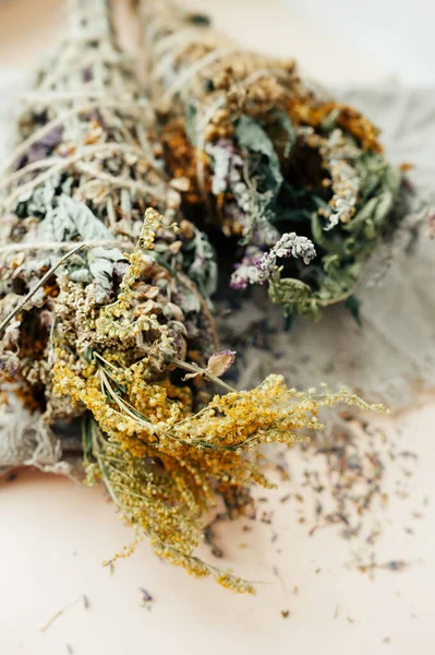 bouquet of dried flowers: lavender, St. John\'s wort grass, buttercups, cornflowers. Dried flowers for aromatherapy. Twists of fragrant grass for fumigation of premises. Selective focus.