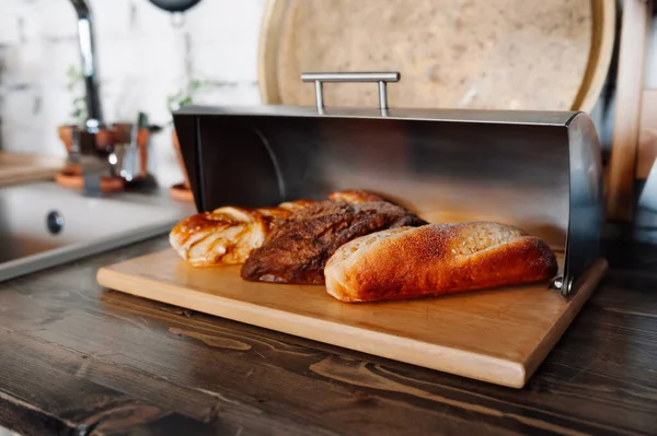 パンの愛は木のキッチンの金属製の銀製のブレッドボックスにあります 自家製ケーキ 選択的焦点 ストック写真
