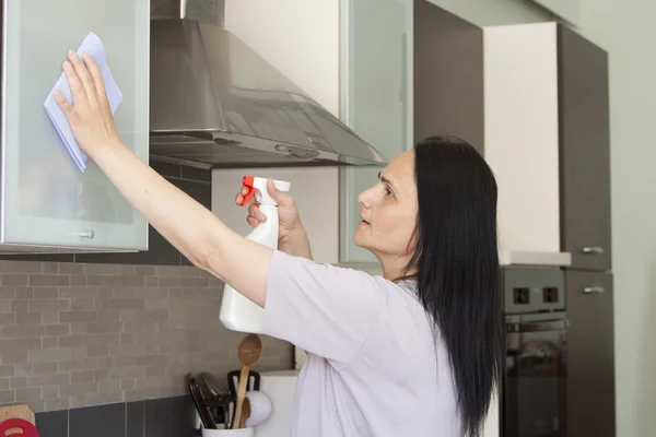 Mujer joven limpiando los muebles —  Fotos de Stock