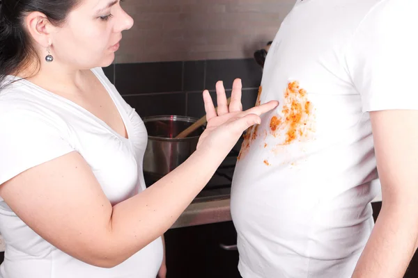 Young man cooking in t-shirt with spots — Stock Photo, Image