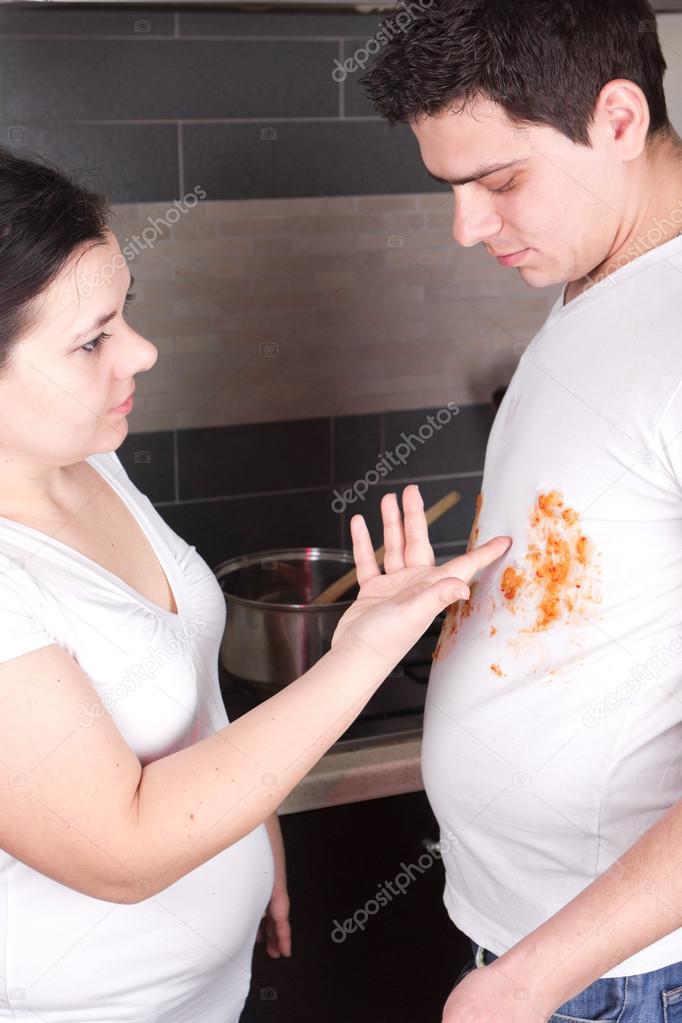 Young man cooking in t-shirt with spots