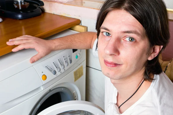 Young man doing laundry at home — Stock Photo, Image