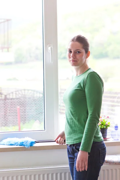 Pretty maid cleaning dust indoor — Stock Photo, Image