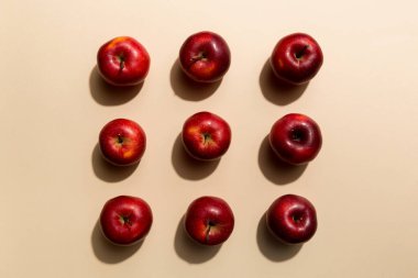 Renkli arka planda bir sürü kırmızı elma, üst manzara. Görüş üzerinde taze elma ile sonbahar deseni.