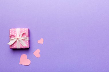 Sevgililer Günü kompozisyonu: Yay ve kalple kırmızı hediye kutusu. Noel hediyesi. Yukarıdan bak. Mesaj için yer var. Holday tebrik kartı.