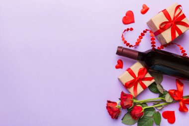 Kırmızı şarap, gül çiçeği ve hediye kutusuyla Sevgililer Günü kompozisyonu. Üst manzara, düz yatış. Tatil kavramı.