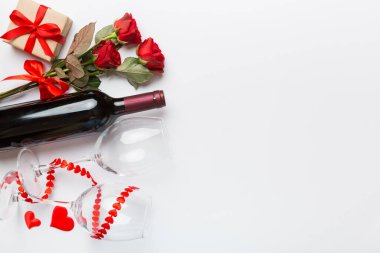 Kırmızı şarap, gül çiçeği ve hediye kutusuyla Sevgililer Günü kompozisyonu. Üst manzara, düz yatış. Tatil kavramı.