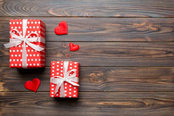 Sevgililer Günü kompozisyonu: Yay ve kalple kırmızı hediye kutusu. Noel hediyesi. Yukarıdan bak. Mesaj için yer var. Holday tebrik kartı.