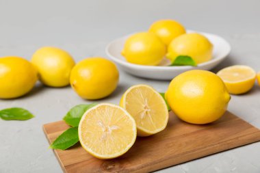Kesme tahtasındaki taze ve olgun limonlar için fotokopi alanı olan üst manzara. Sağlıklı yemek geçmişi. Limon ve limon dilimlerinin zarif arkaplanı daha sıkan renkli arkaplan.