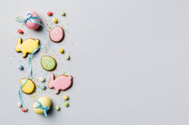 bayram hazırlığı renkli arka planda kurabiyeli çok renkli Paskalya yumurtaları. Pastel renginde Paskalya yumurtası. Kopyalama alanı olan tatil kavramı.