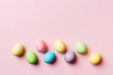 Bayram hazırlığı. Renkli arka planda Paskalya yumurtaları. Pastel renginde Paskalya yumurtası. Kopyalama alanı olan tatil kavramı.