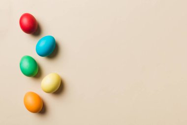 Bayram hazırlığı. Renkli arka planda Paskalya yumurtaları. Pastel renginde Paskalya yumurtası. Kopyalama alanı olan tatil kavramı.